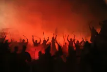 dramatic nighttime photo of warriors silhouetted against fiery red