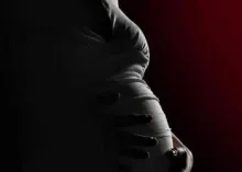 Pregnant women holding her belly.