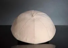 White papal zucchetto worn by the Pope.