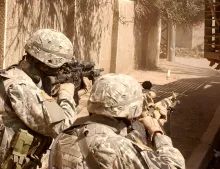 United States troops aiming guns.