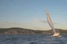 A sailboat leaning into the wind.