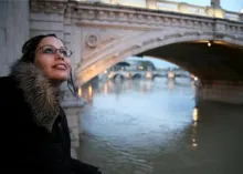 A young woman looking up at the sky.