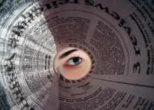 looking through a rolled newspaper
