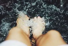 A person's feet in water.