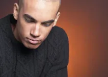 A young man looking down.