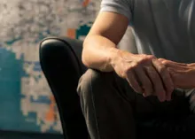 Man sitting in leather chair.