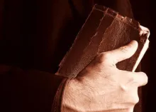 old Bible in hand