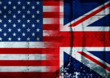 United States and Great Britain flags painted on steel looking background.