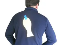 man with paper fish taped on back