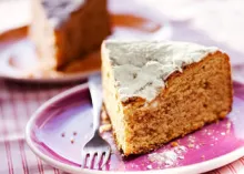 A piece of cake on a plate with a fork.