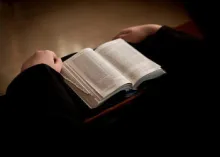 A person reading a Bible.