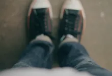 Looking down at the floor and shoes.