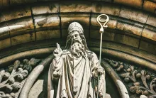 a statue of St. Patrick outside a church archway