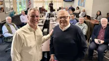 Group of men in a conference room smiling into the camera