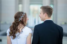 a bride and a groom smiling at one another