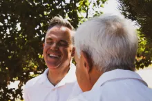 two men talking outside