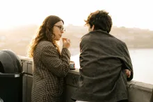 A man and woman talking. 