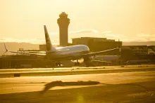 Plane landing with a shadow underneath it