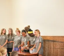 Campers laughing and playing a game