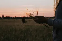 A woman holding some grain in her hands.