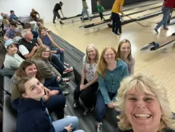 a group of people seated in a bowling alley