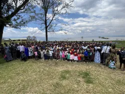 a large group of people gathered on the lawn