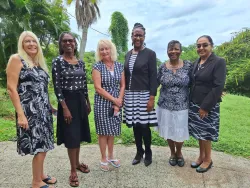 six women standing outside