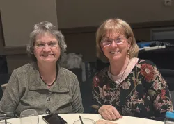 two women seated at a table
