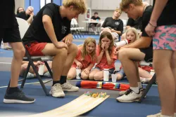Three girls racing wooden cars