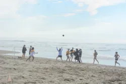 Campers playing speedaway on a beach