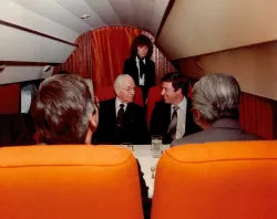 four people inside an old fashioned airplane