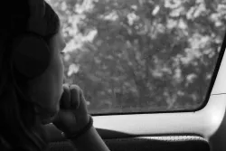 a woman looking out a car window