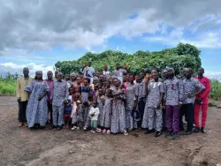 a large group of people gathered outdoors with many wearing matching clothing