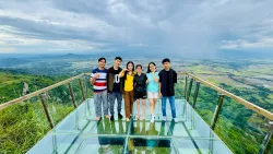 six people standing on a balcony