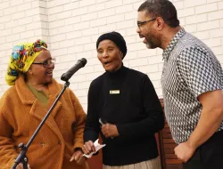 three people talking with a microphone in front