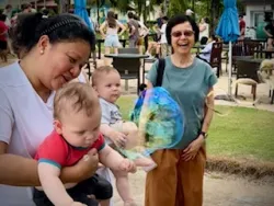 people outside blowing bubbles