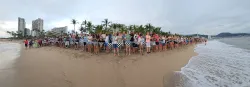 a large group of people gathered on the beach