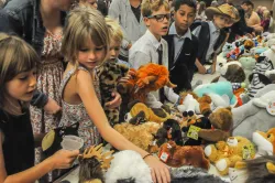 a group of children selecting plush animals