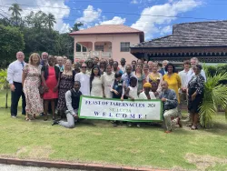 a group of people standing outside with a Feast of Tabernacles welcome banner