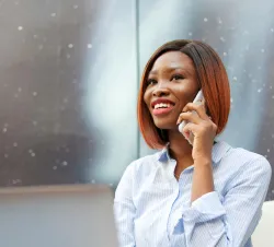 a woman holding a cell phone to her ear
