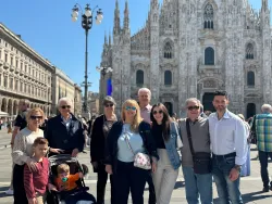 a group of people standing in front of a historical building