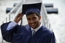 a man wearing a graduation cap and gown