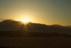The sun setting over a mountain range.