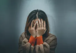 a woman with her head in her hands