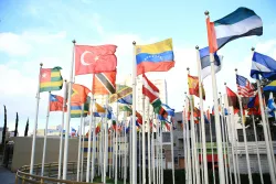 a group of national flags outdoors on flagpoles