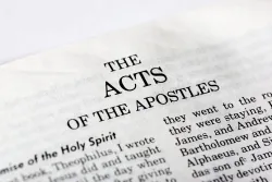 A Bible opened to the book of Acts.