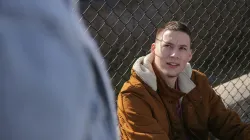 a young man looking up with a quizzical frown on his face