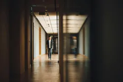 A young man walking in a school hallway