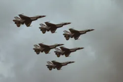 six fighter jets in a gray sky