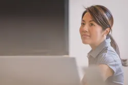 A woman sitting a table.